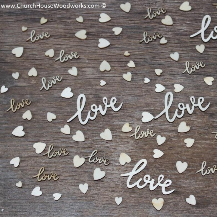 "100-piece set of natural wood decorations including 'love' cursive words and mixed hearts, displayed with a quarter for size reference."