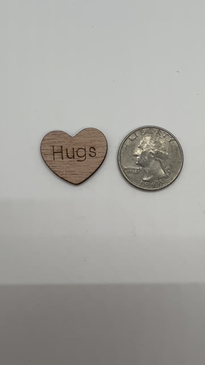 1 inch wood hearts with the word Hugs on them confetti